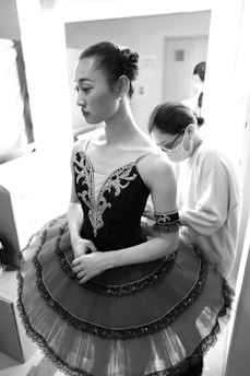 a woman in a dress is standing in a room