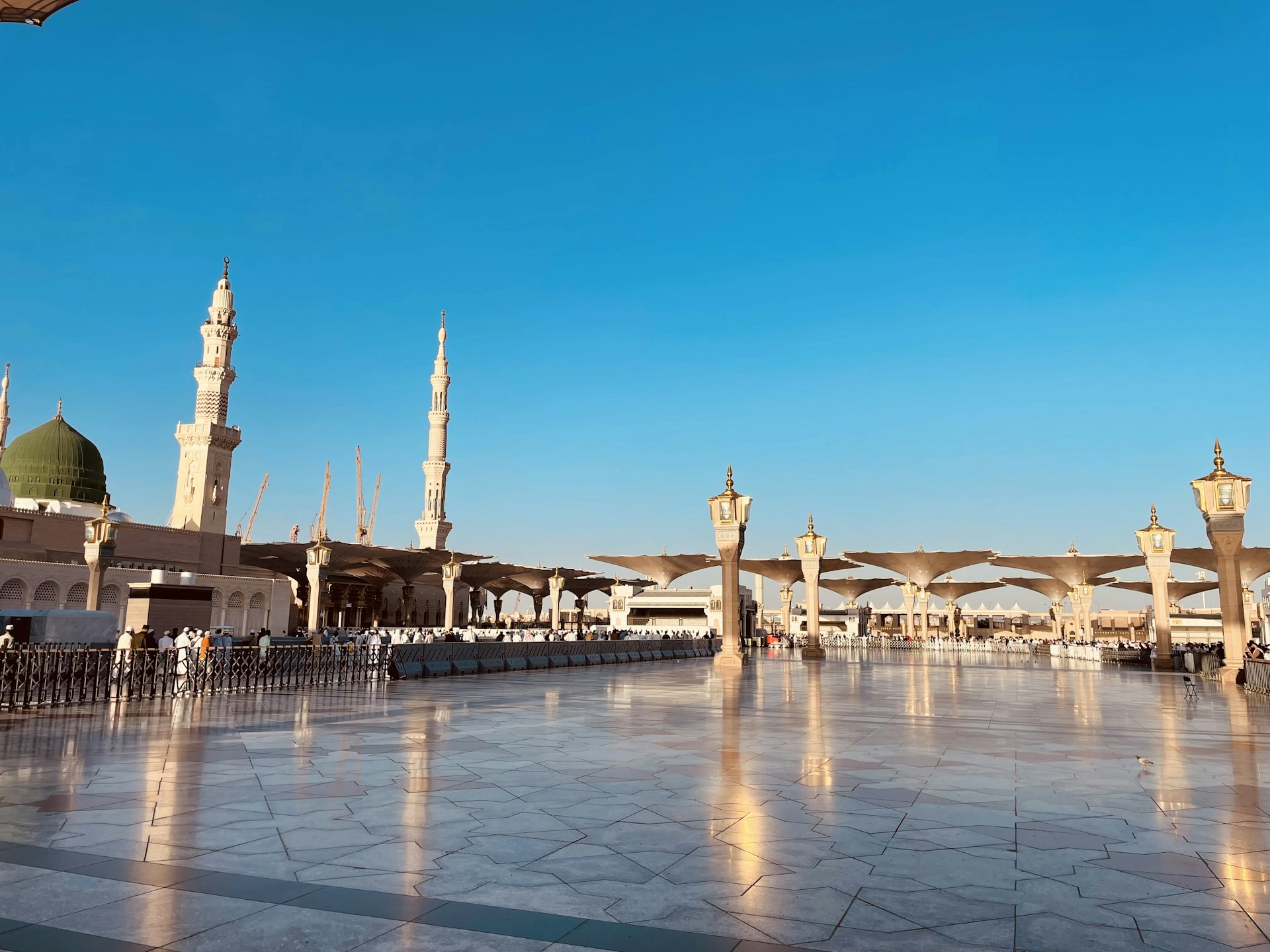 a large courtyard with a clock tower in the background