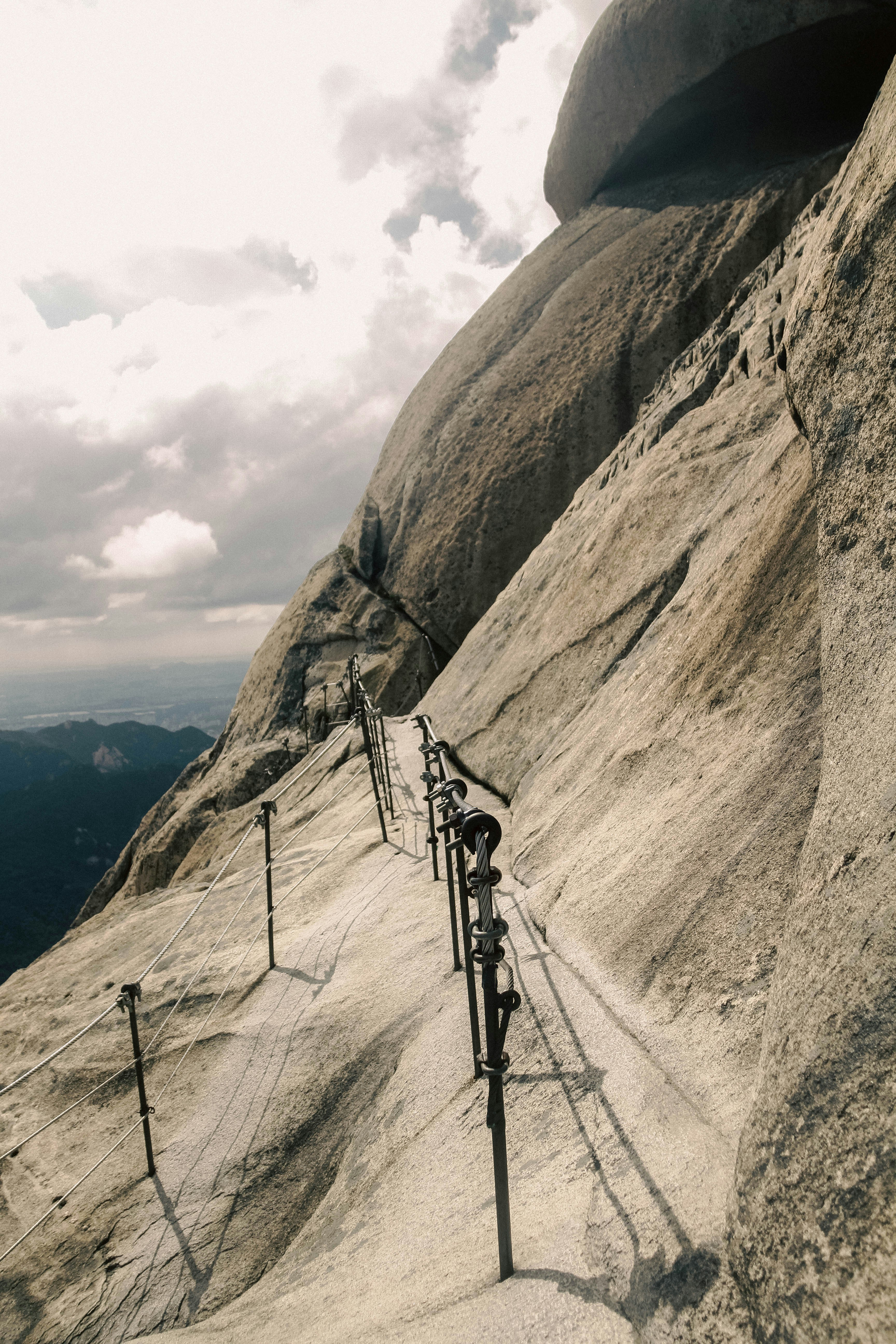 A long metal railing on the side of a mountain photo – Free Seoul Image ...