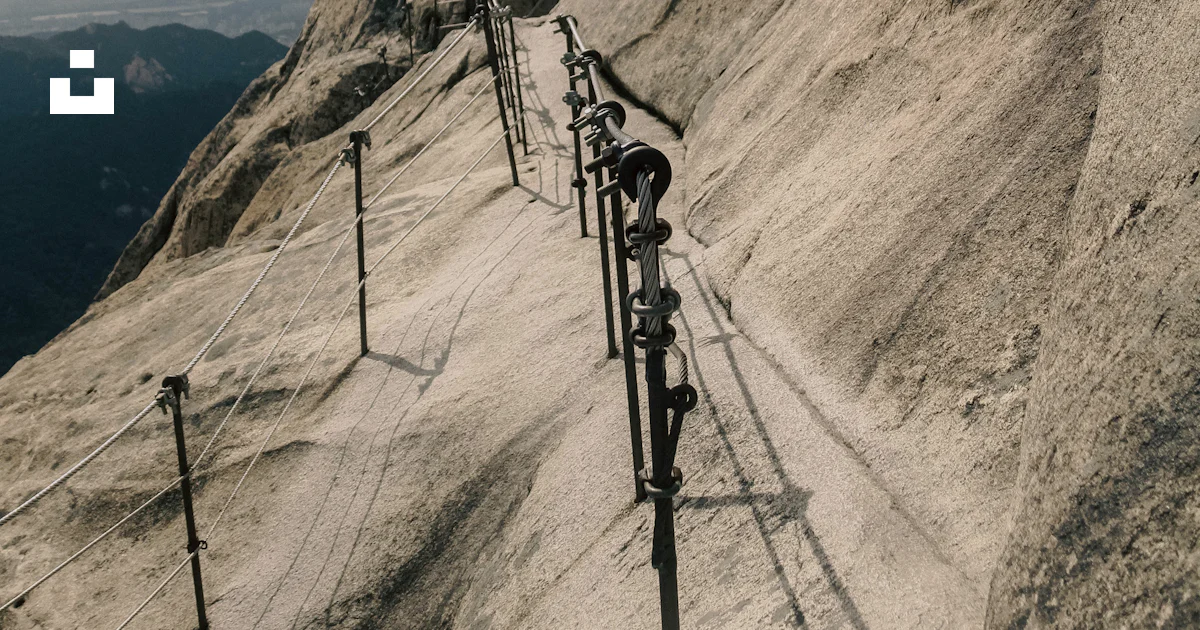 Mountain Summit Railing A long metal railing on the side of a mountain photo – Free Seoul Image ...