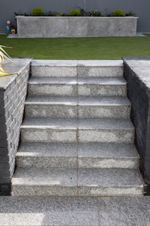 a stone staircase leading up to a grassy area