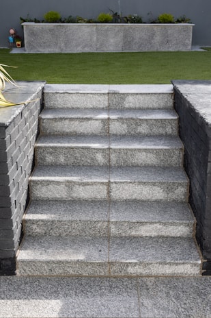a stone staircase leading up to a grassy area