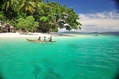 a couple of people in a small boat in the water