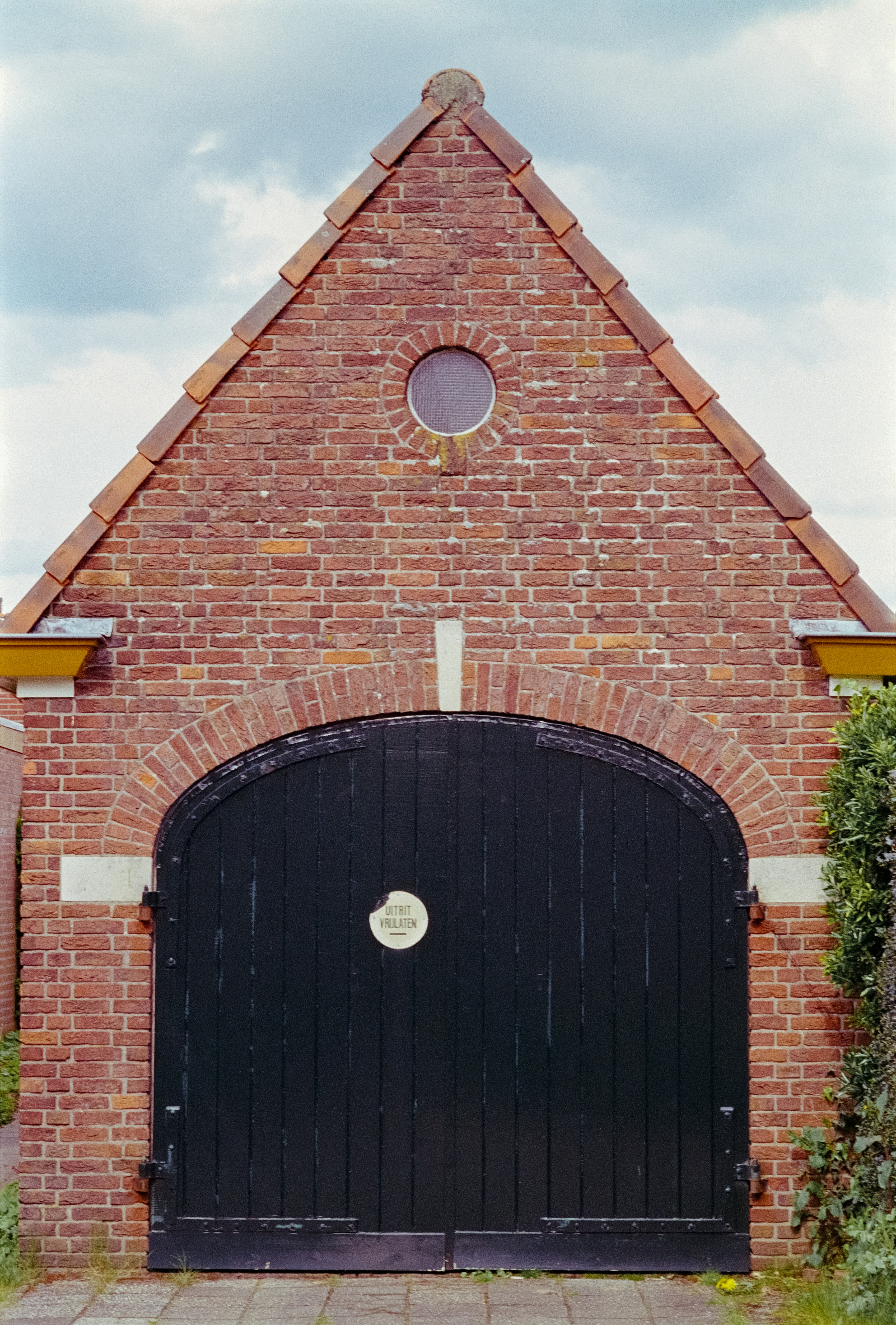 Arched carriage-style garage door on a Spanish-style home in La Quinta CA