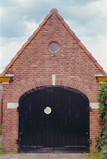 a brick building with a large black door