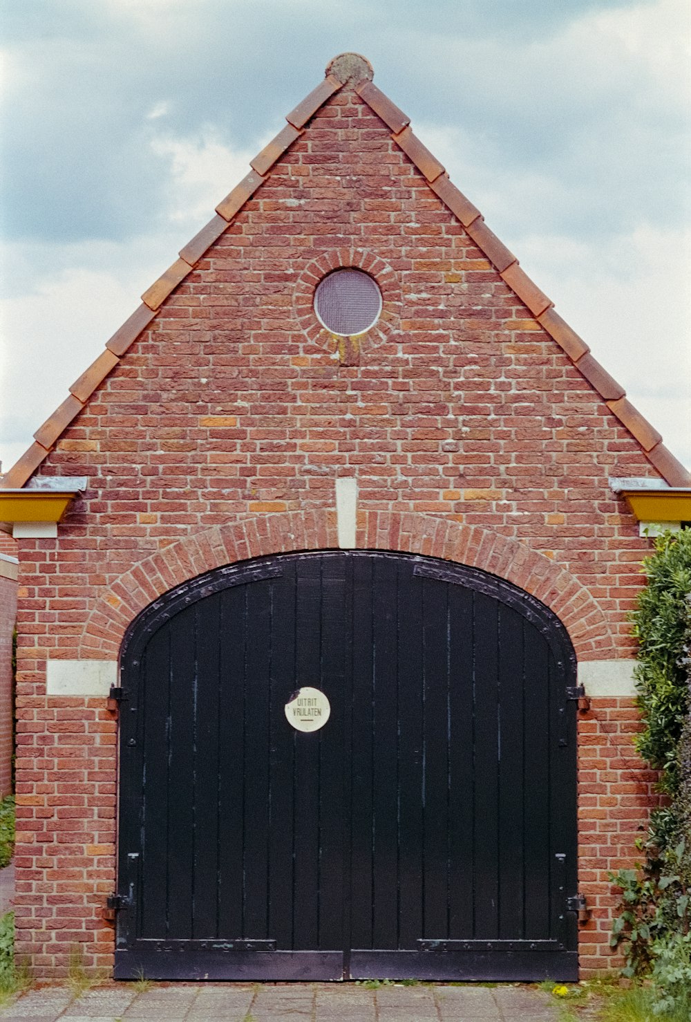 a brick building with a large black door
