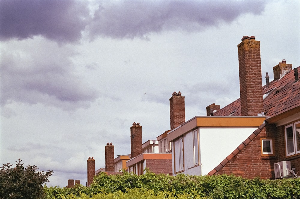 a row of houses with a clock tower in the background