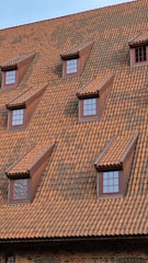 a clock on the side of a brick building