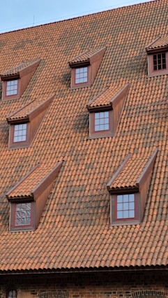 a clock on the side of a brick building