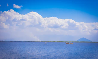 a couple of boats floating on top of a large body of water