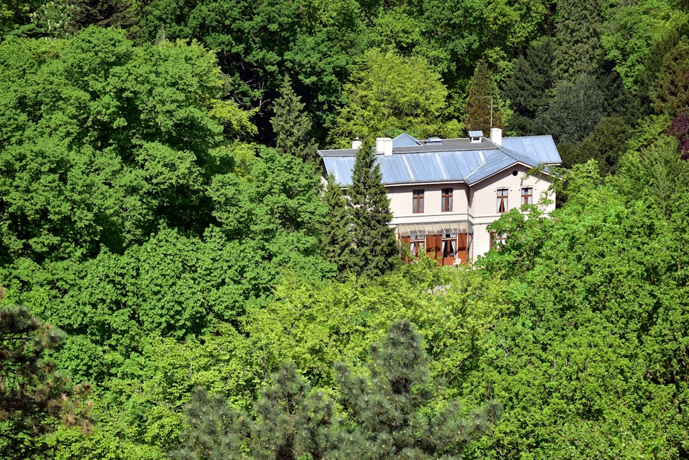 an aerial view of a house surrounded by trees