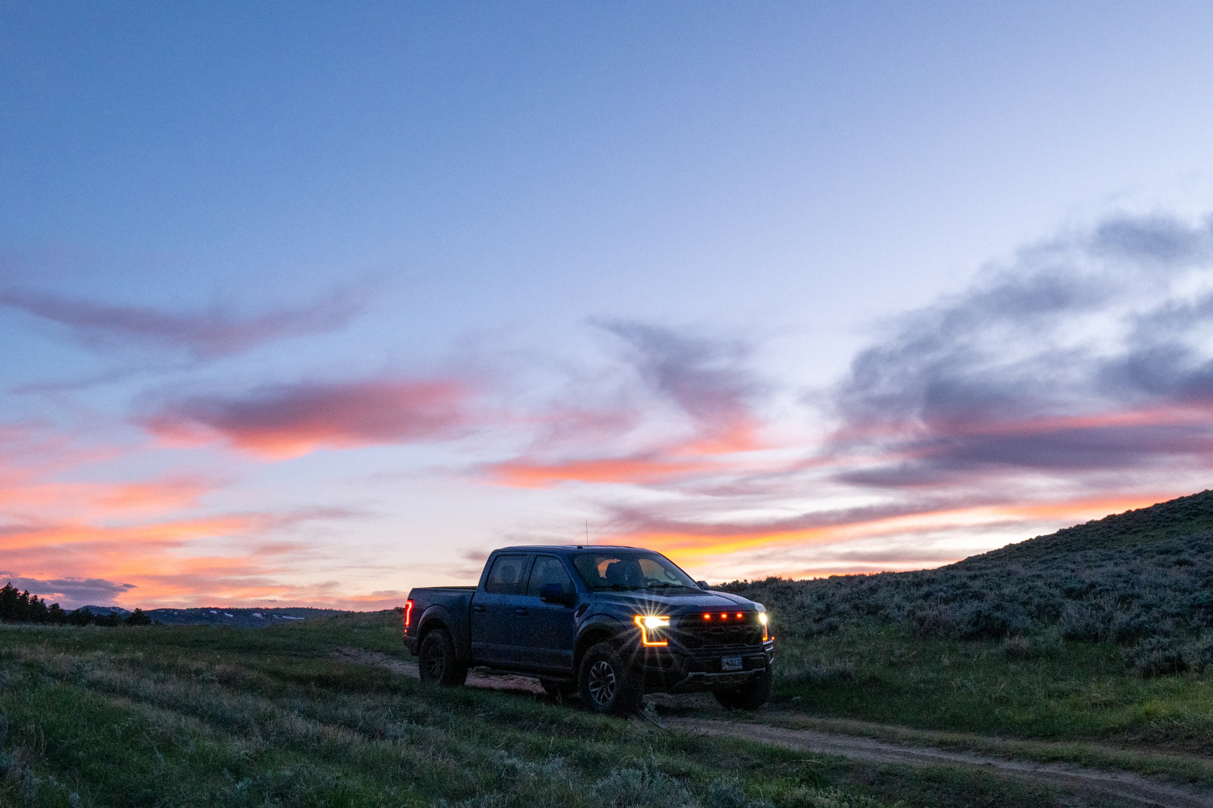 Ford F-150 Raptor at sunset in the foothills