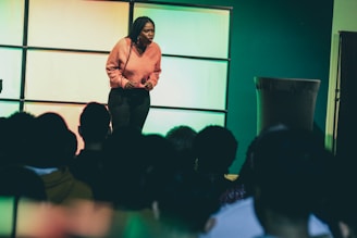 a woman standing on a stage in front of a crowd