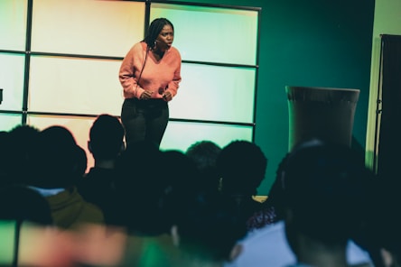 a woman standing on a stage in front of a crowd