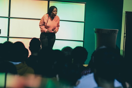 a woman standing on a stage in front of a crowd