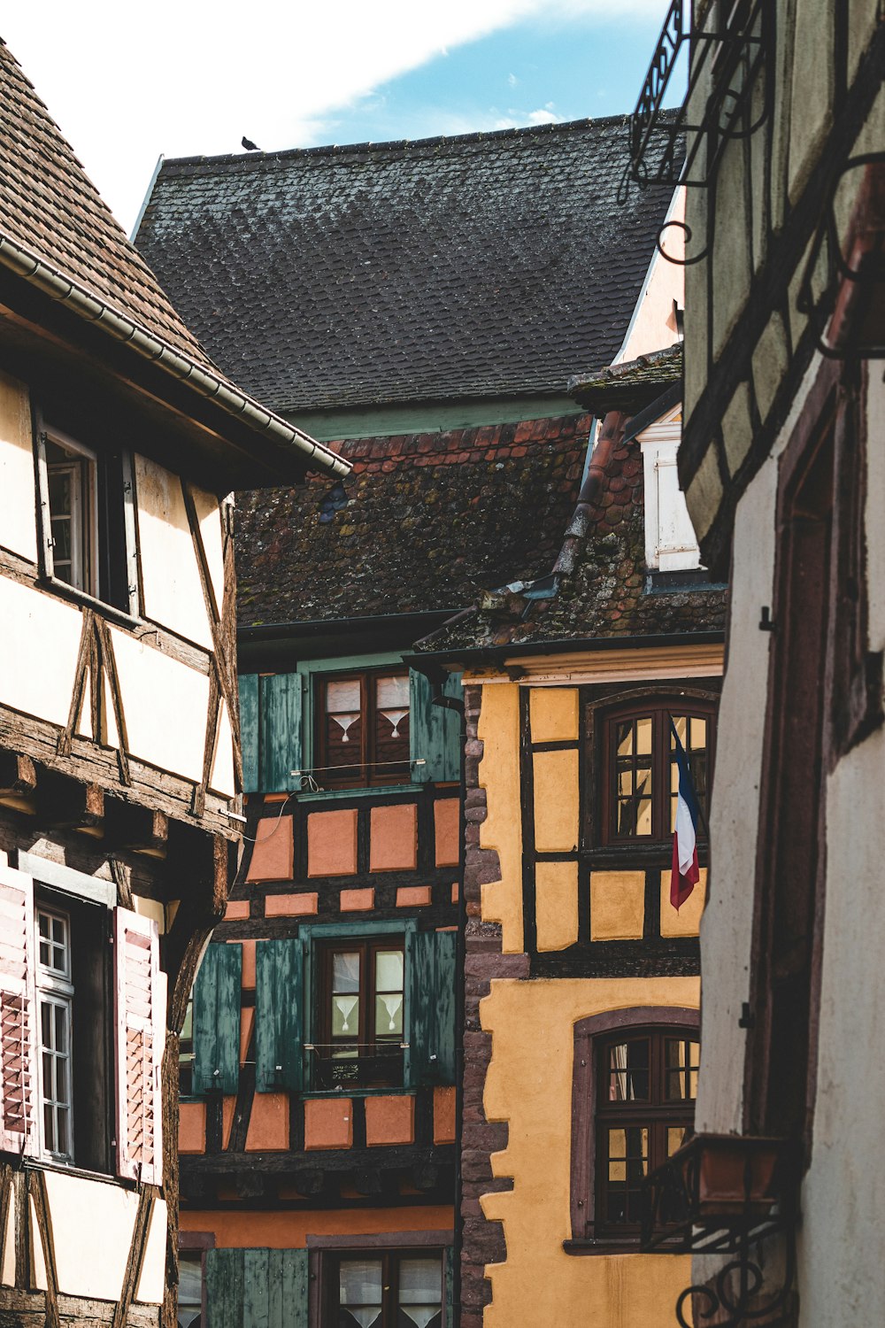 a row of buildings with windows and shutters