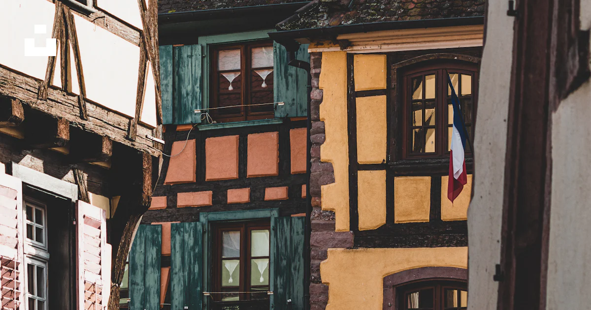 A row of buildings with windows and shutters photo – Free House Image ...