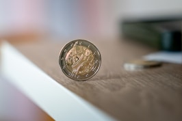 a coin sitting on top of a wooden table