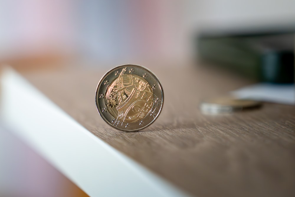 a coin sitting on top of a wooden table