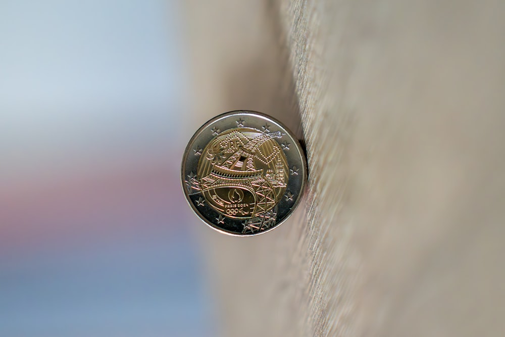 a close up of a coin on a wall
