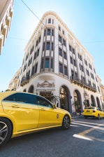 a yellow car is parked in front of a building