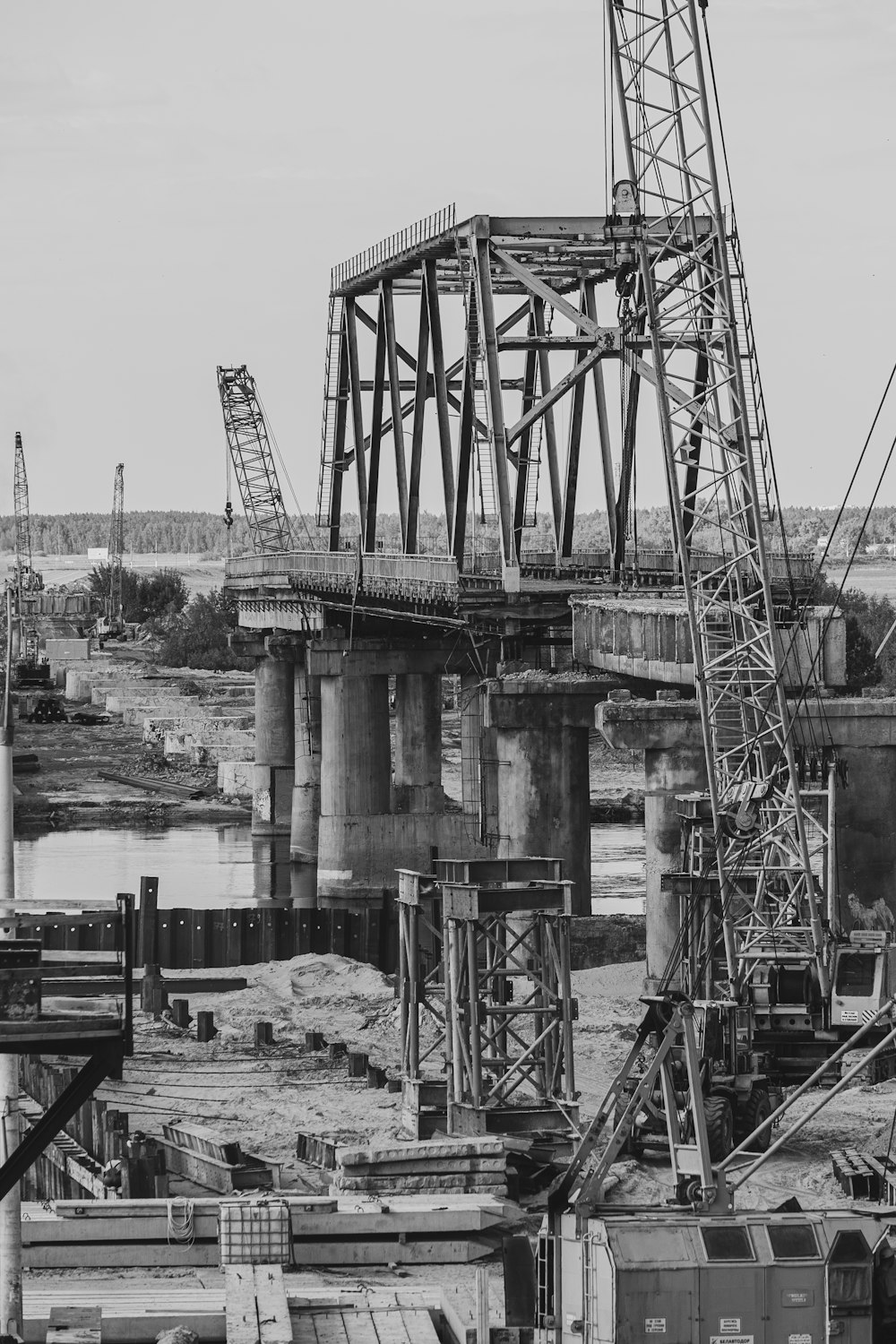 a black and white photo of a train bridge
