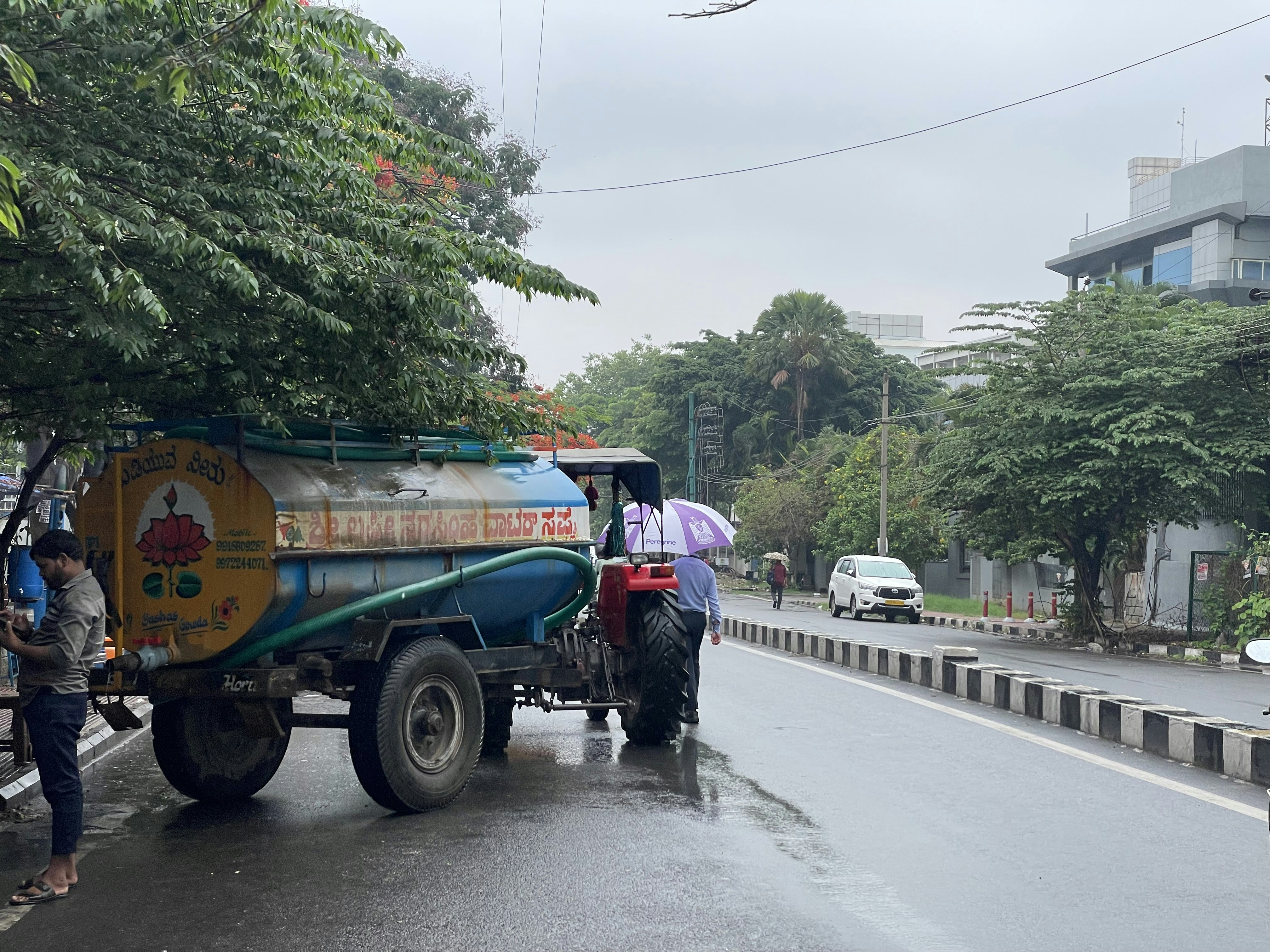 a tractor pulling a trailer down a street