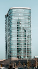 a very tall building sitting next to a body of water