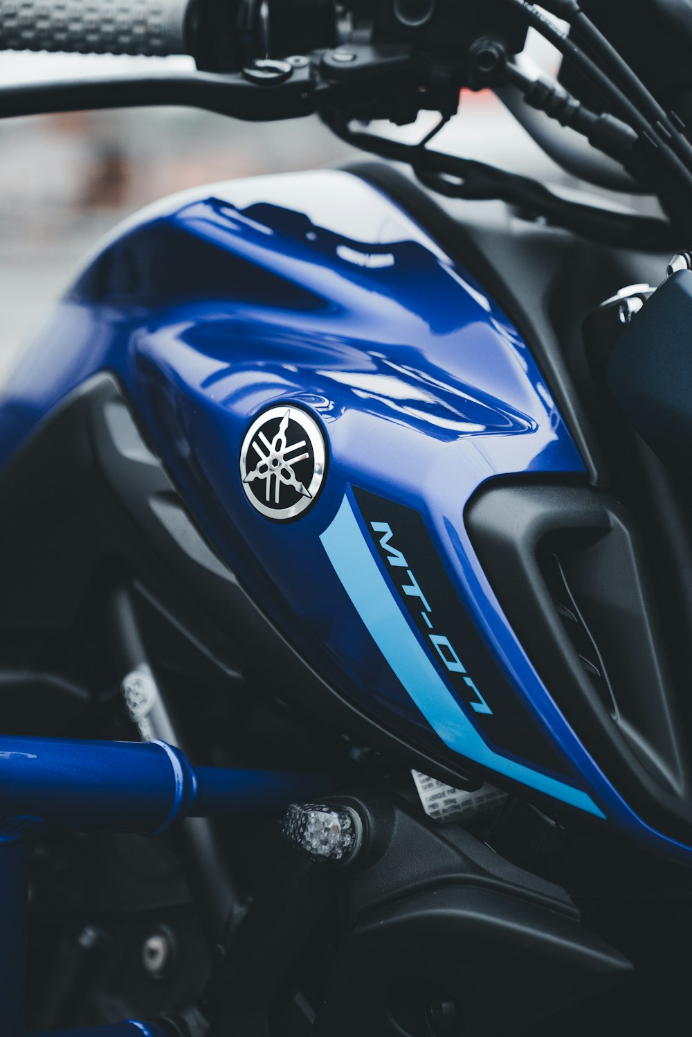 a close up of a blue and black motorcycle