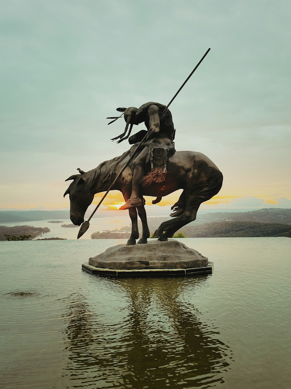 a statue of a man on a horse in the water