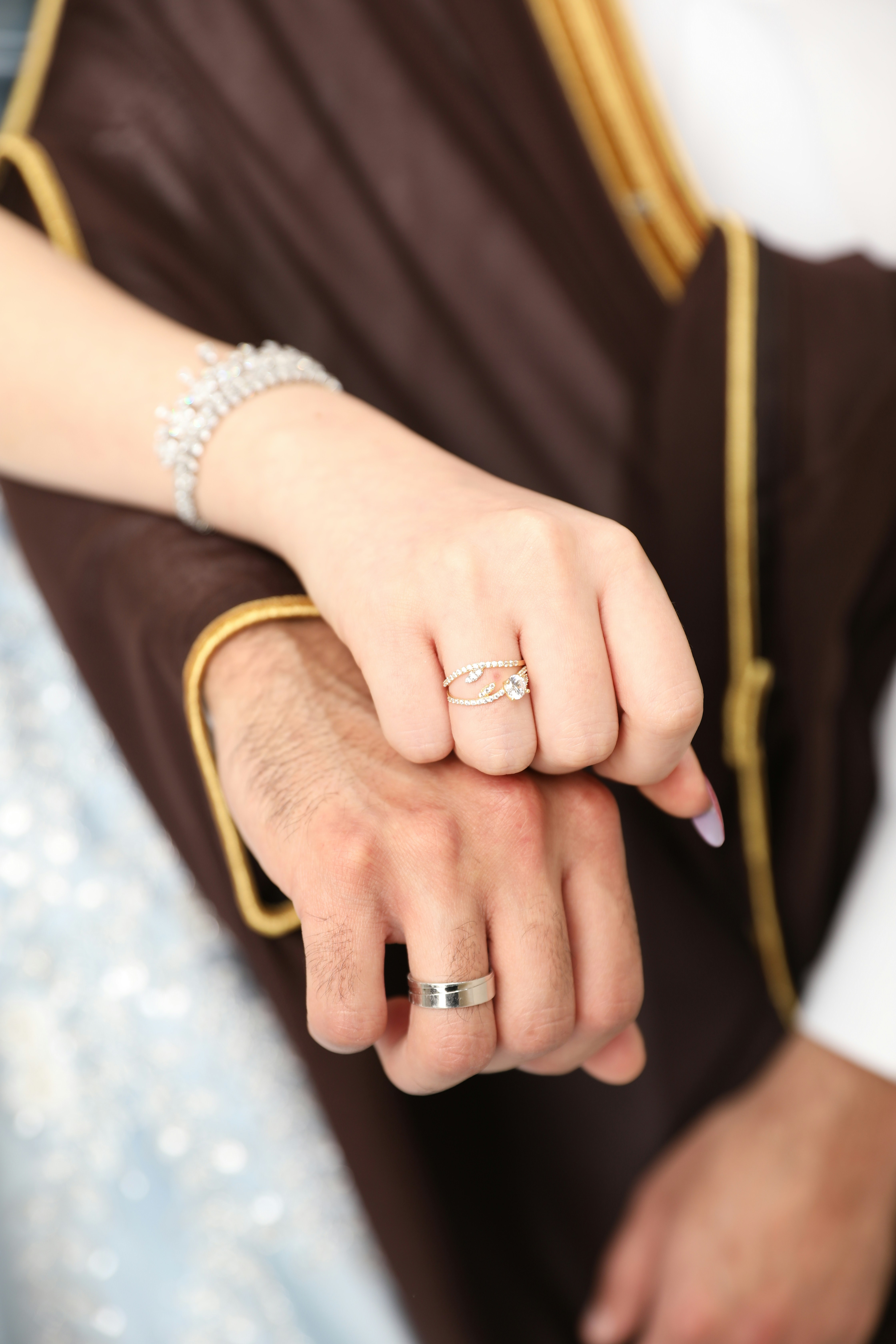 a close up of a person holding a wedding ring