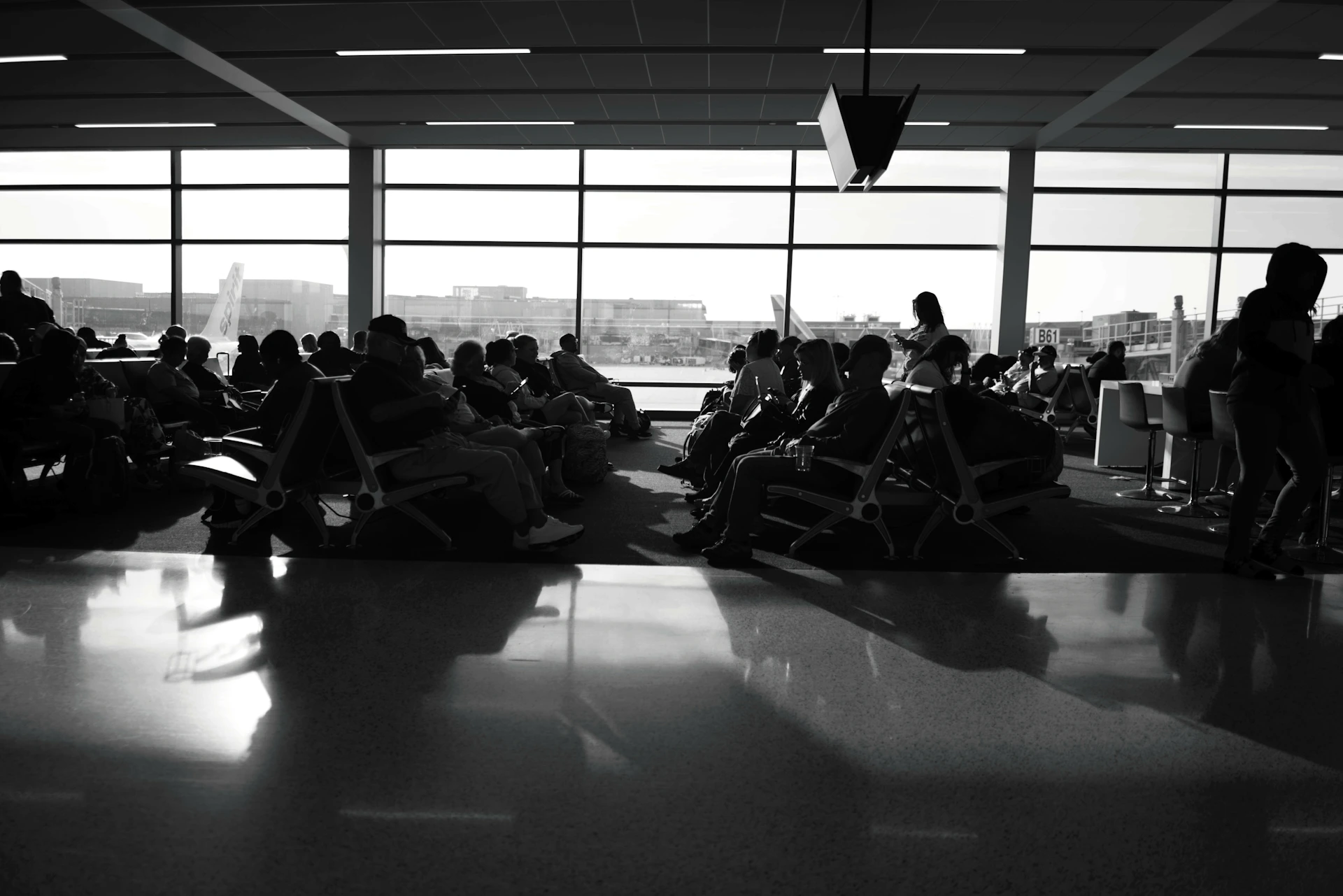 a black and white photo of people sitting in chairs