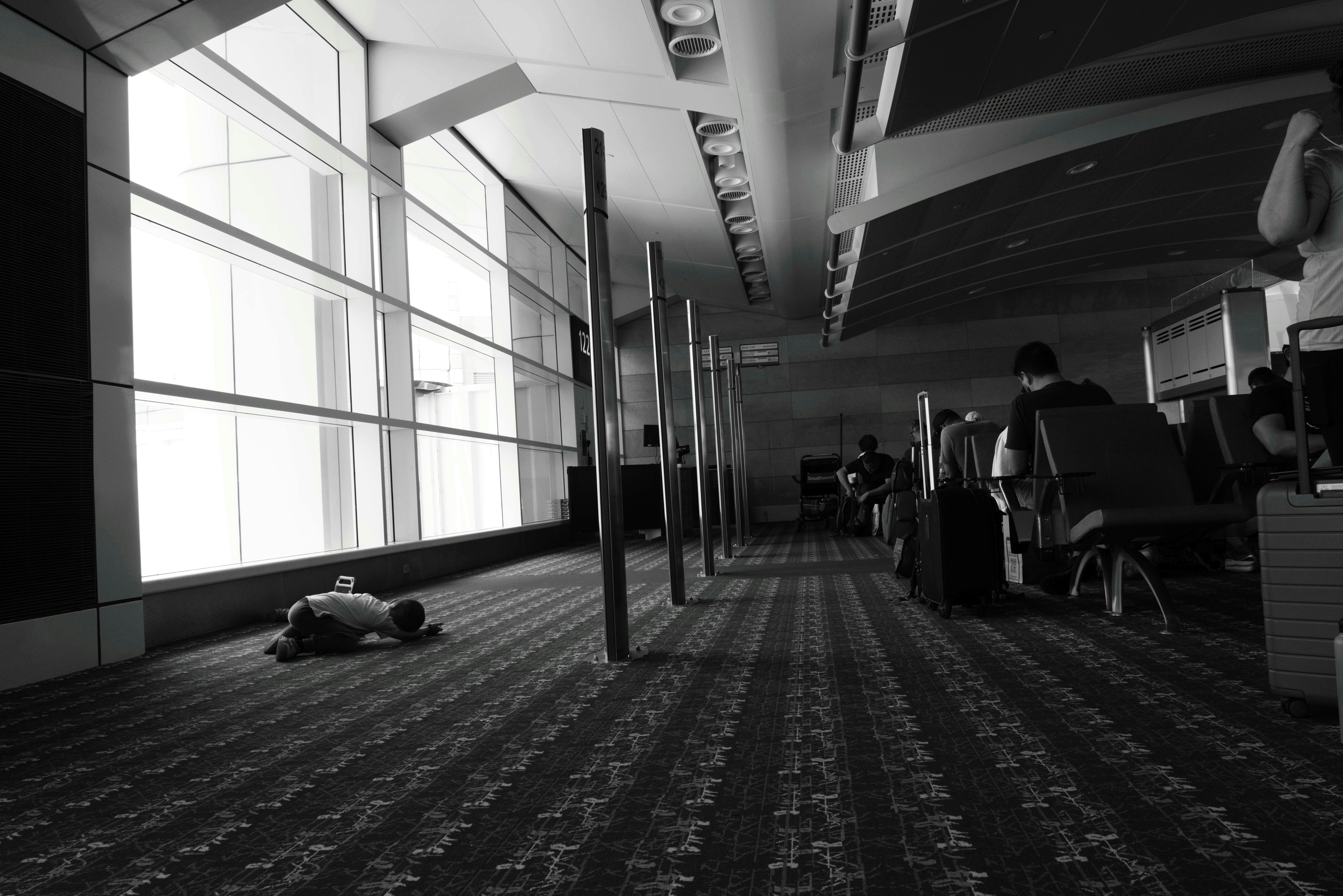 a black and white photo of a person laying on the floor, 