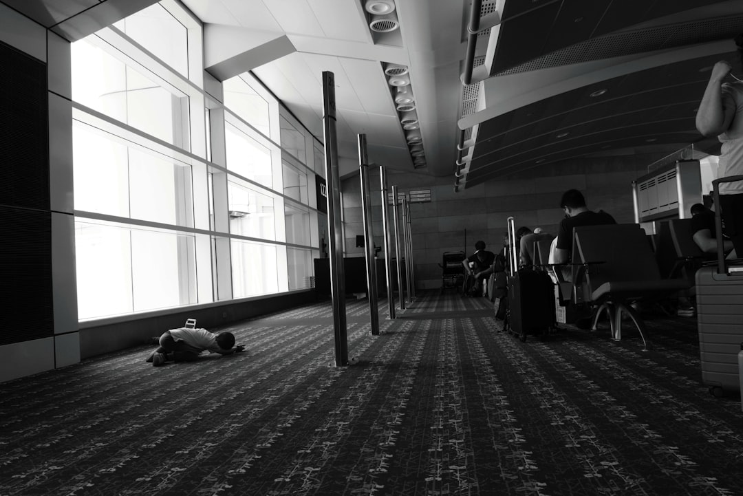 a black and white photo of a person laying on the floor,