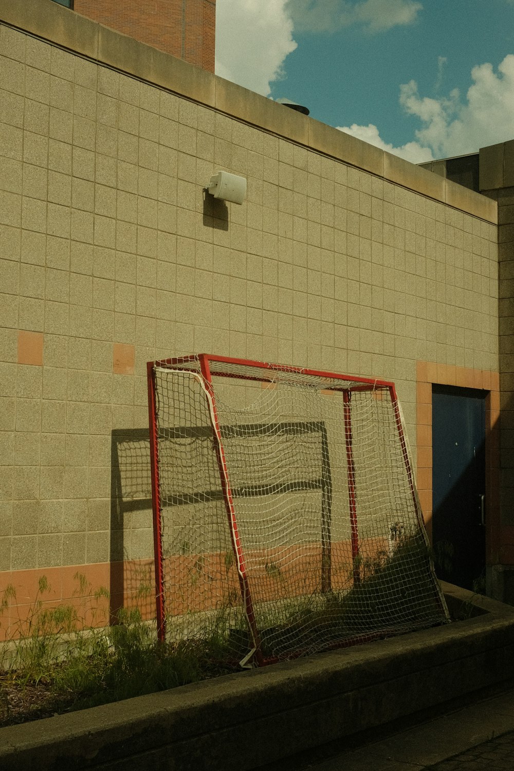 a soccer goal and net in front of a building