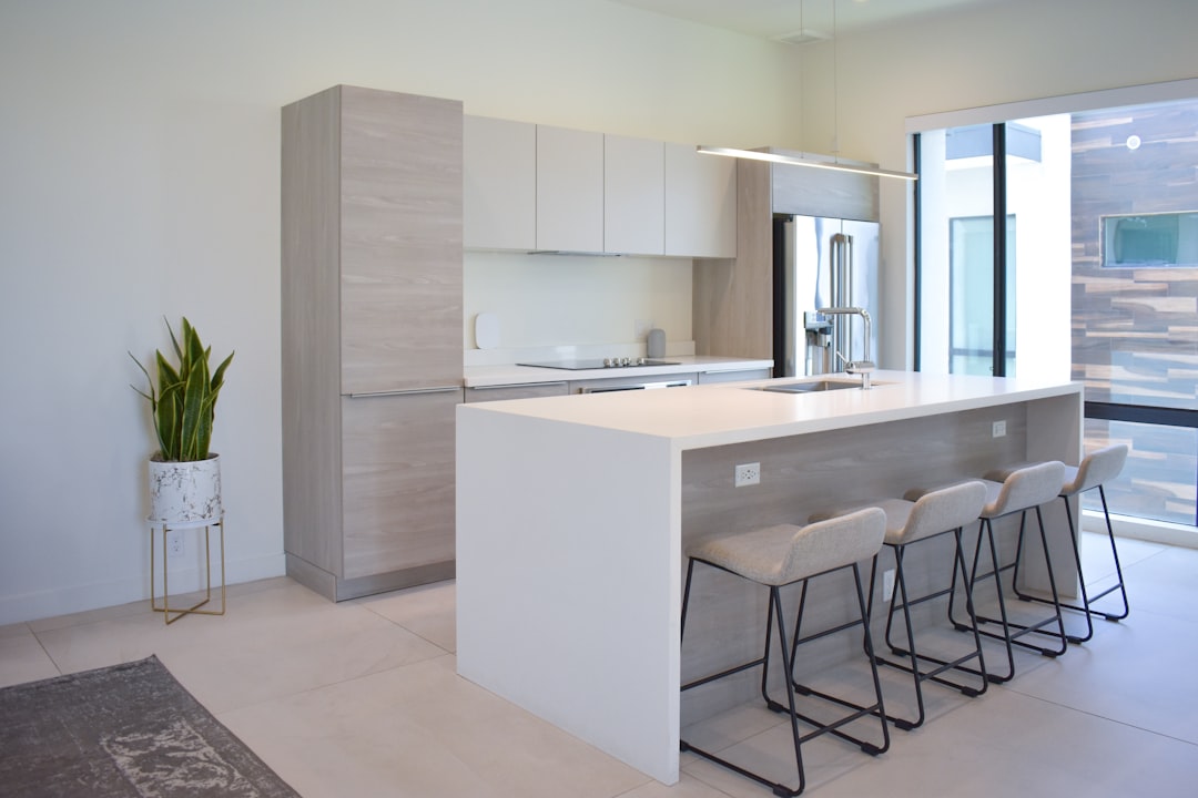a kitchen with a center island with four stools