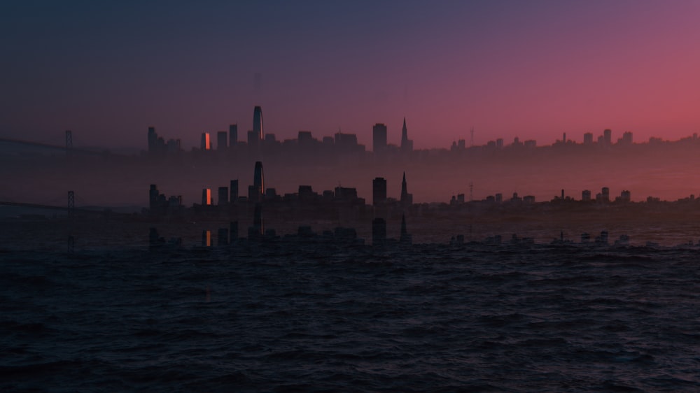 a large body of water with a city in the background