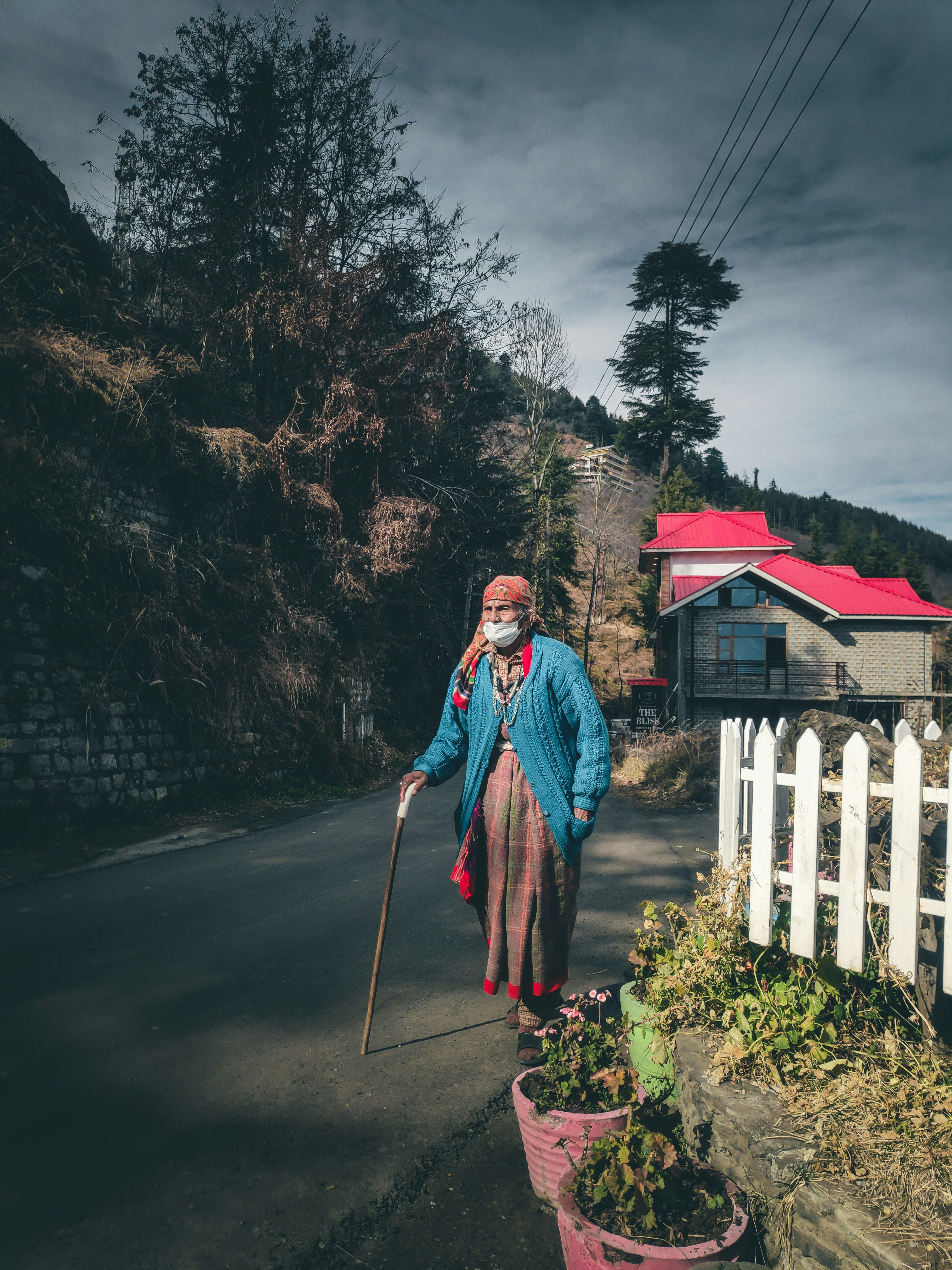 a man walking down the street with a cane