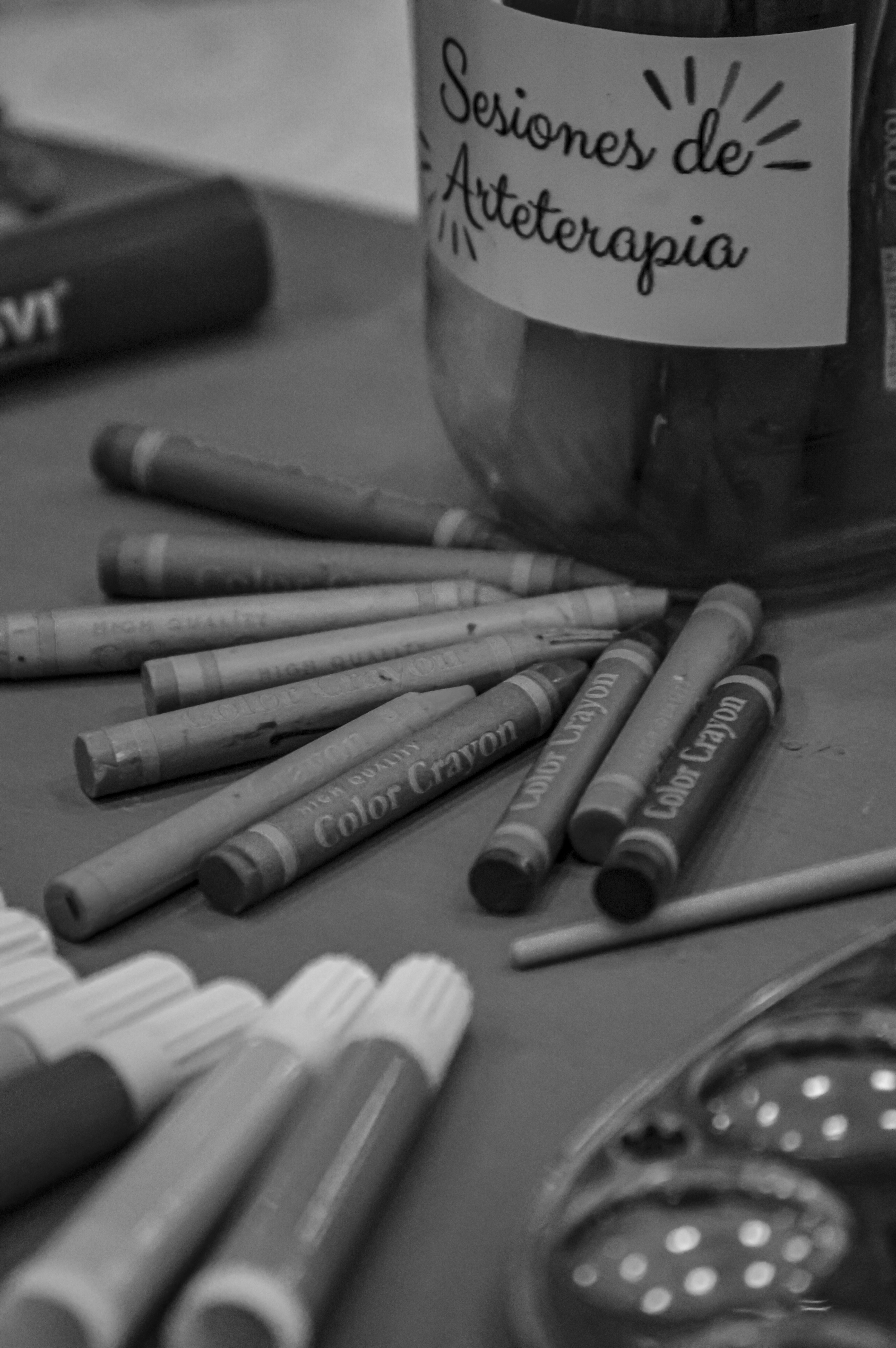 a jar of crayons sitting on top of a table
