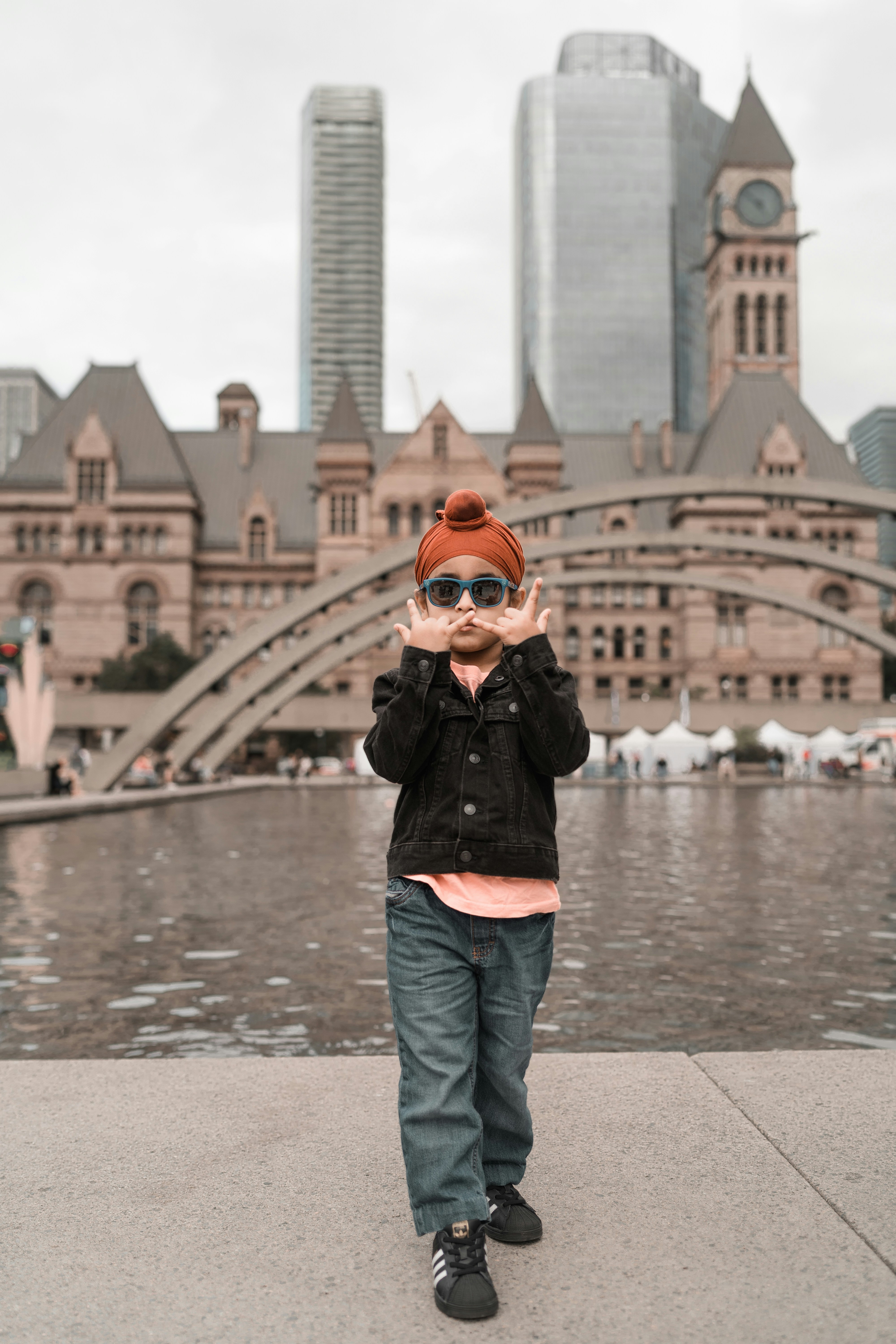 a young boy wearing sunglasses and a red hat