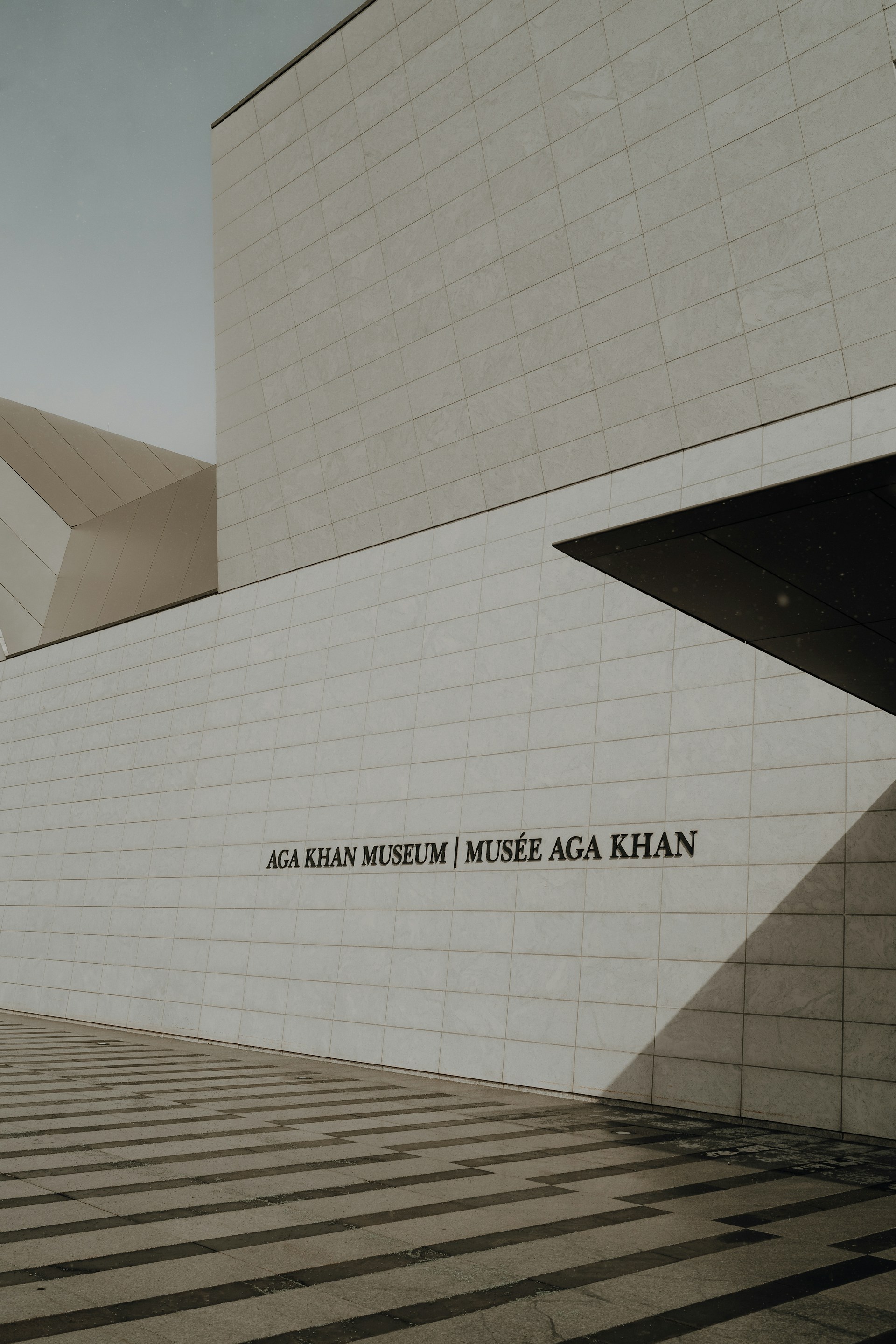 a white building with a black and white striped floor