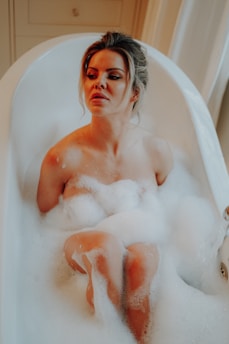 a woman sitting in a bathtub full of foam in Rishikesh Spa