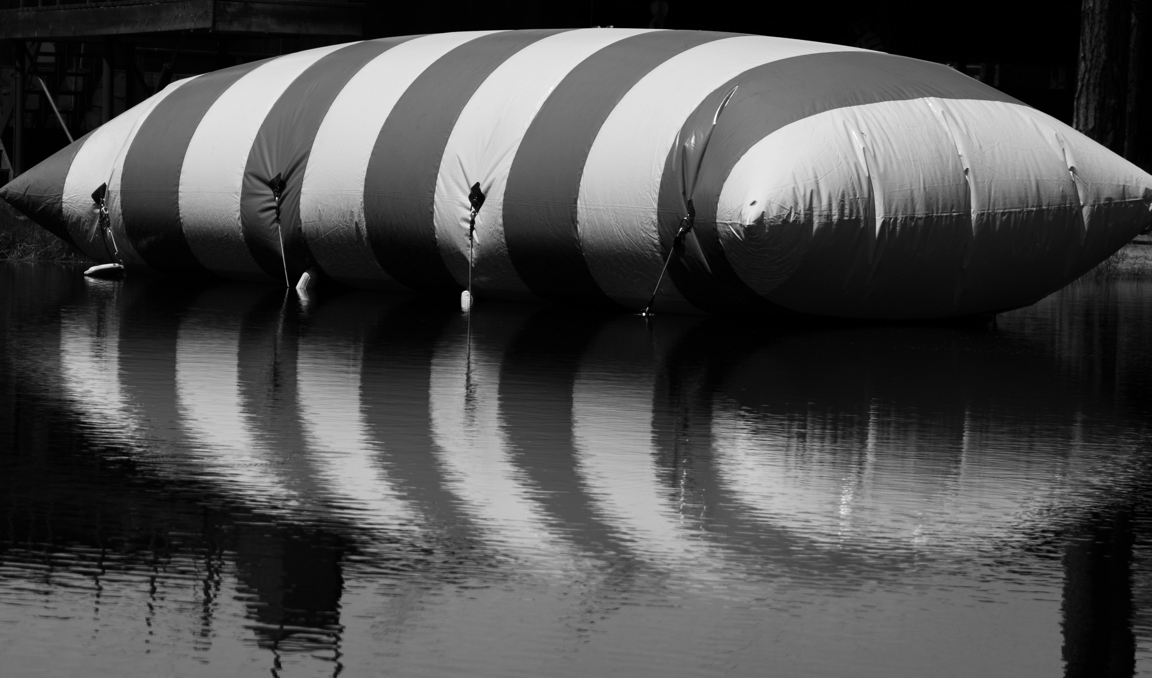 a large inflatable object floating on top of a body of water