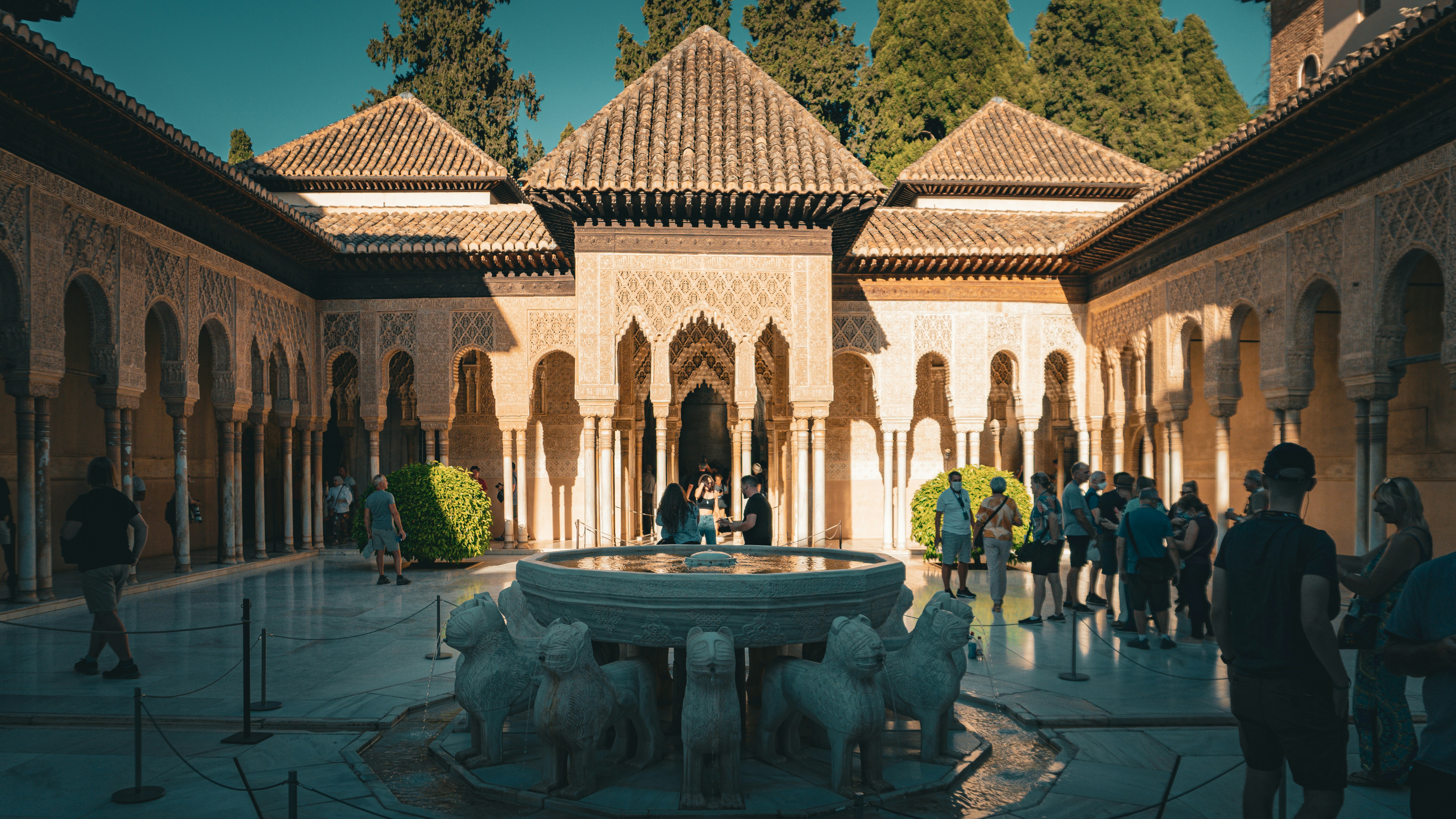 a group of people standing around a fountain
