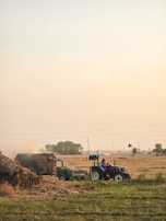 a tractor and a tractor trailer in a field