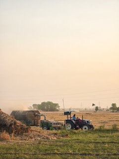 a tractor and a tractor trailer in a field