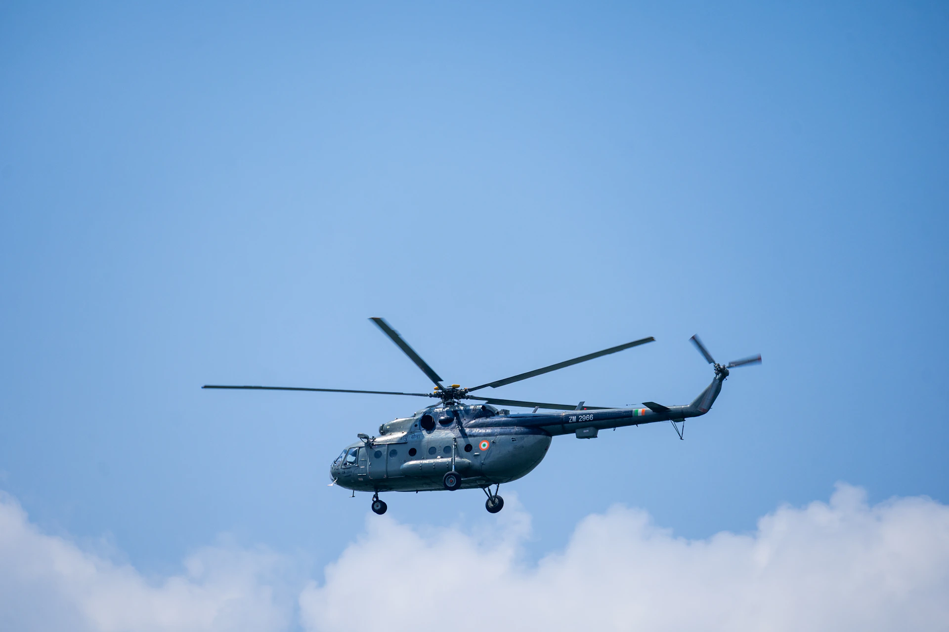 a large helicopter flying through a blue sky