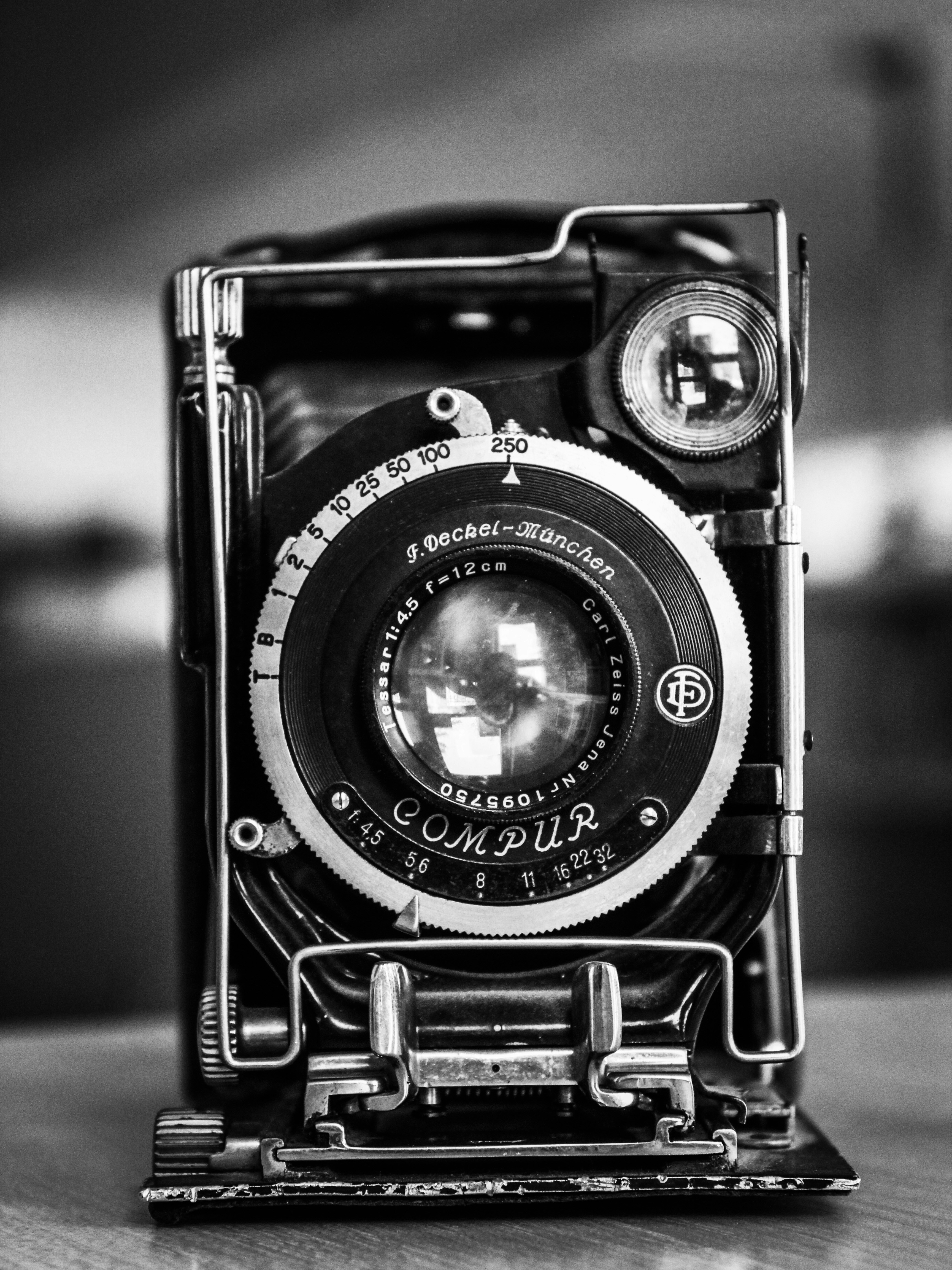 a black and white photo of an old camera