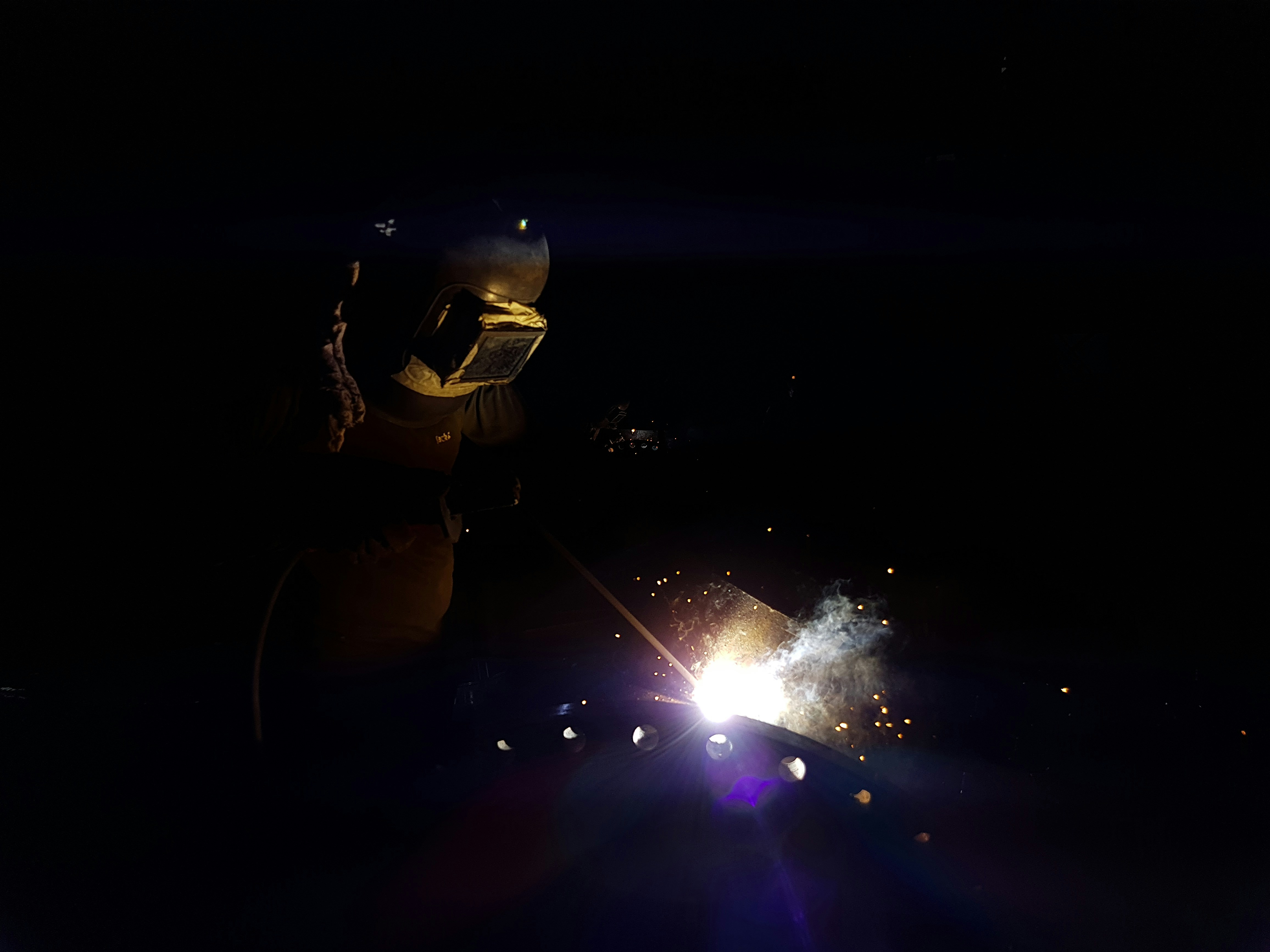 a person holding a sparkler in the dark