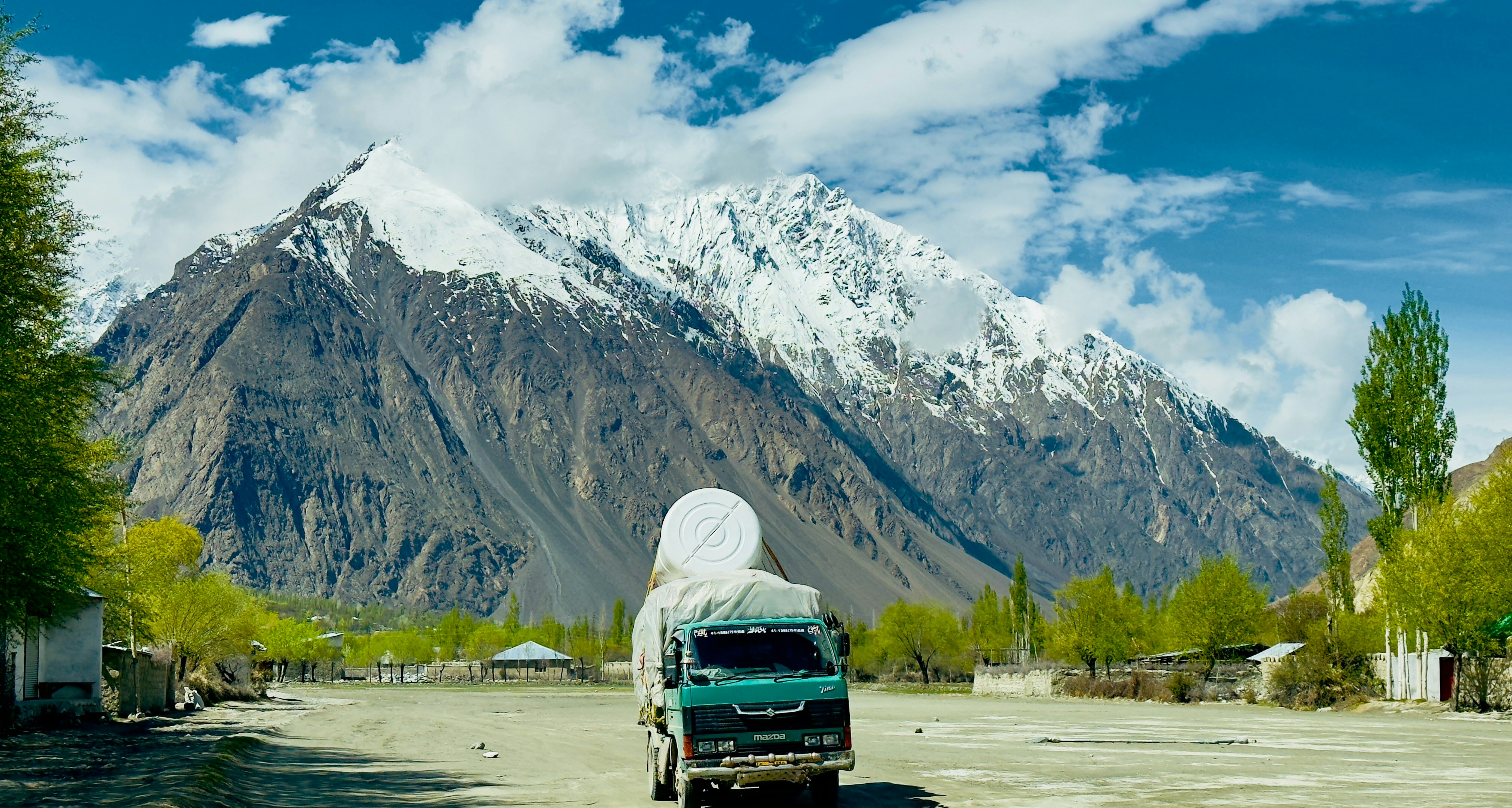 a truck is parked in front of a mountain